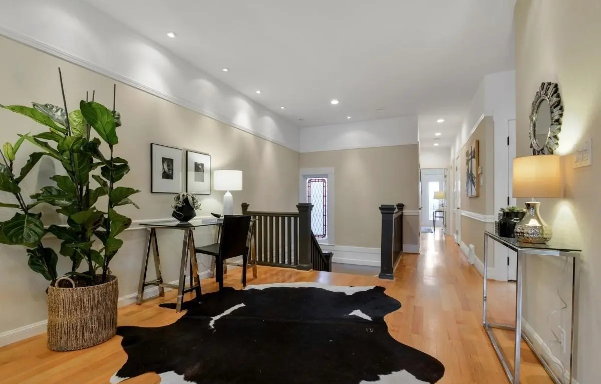 Renovated Edwardian foyer and hallway with home office nook and decorative lighting in a Lower Haight condo.
