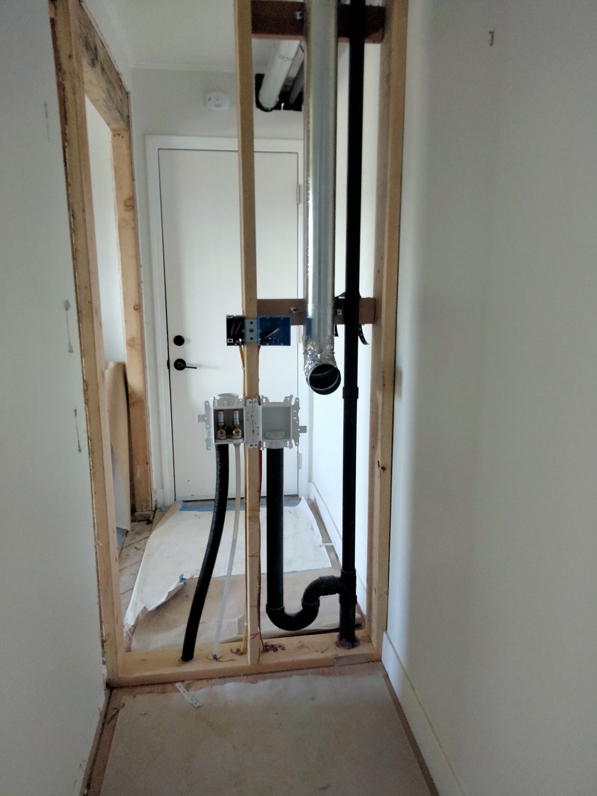 San Francisco recessed laundry rough-in with ABS drain and PEX water lines installed in framed wall.