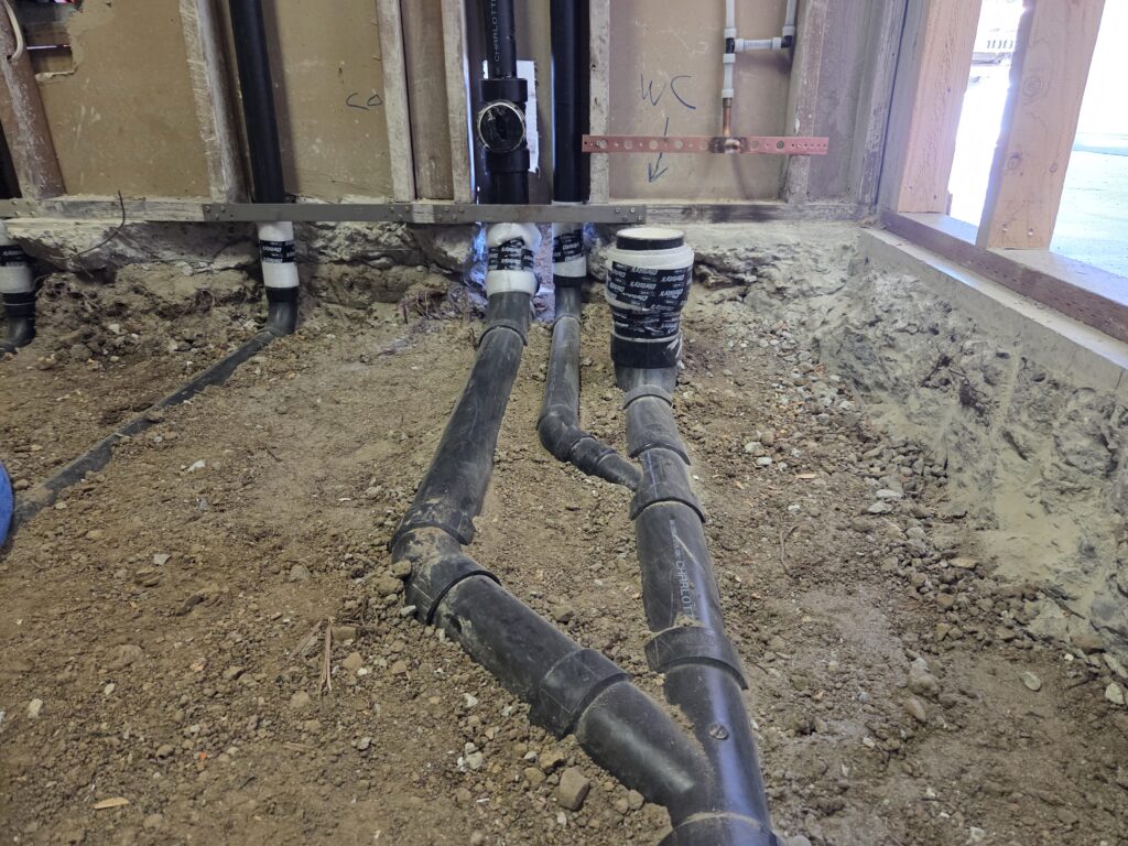 Toilet rough-in groundwork with horizontal vent and cleanout access in San Francisco Bay Area.