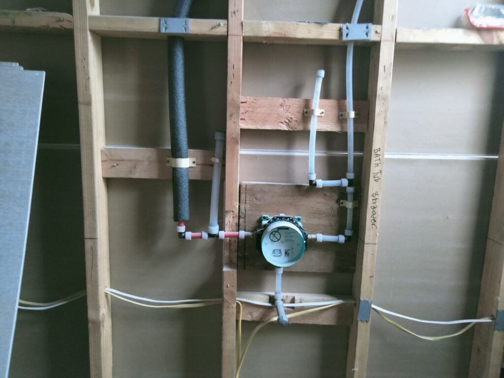 Hansgrohe iBox tub valve PEX rough-in installation with insulation and precise framing in San Francisco bathroom.