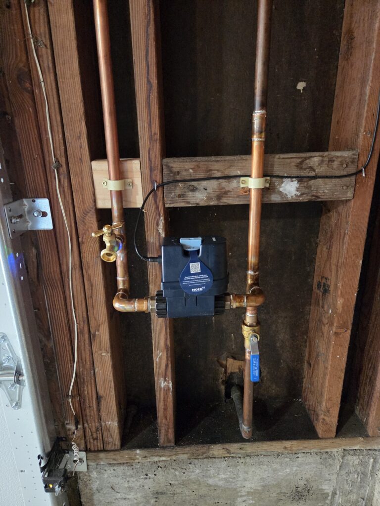 Moen Flo ¾-inch smart water shutoff mounted in residential garage for automated leak detection in San Francisco.