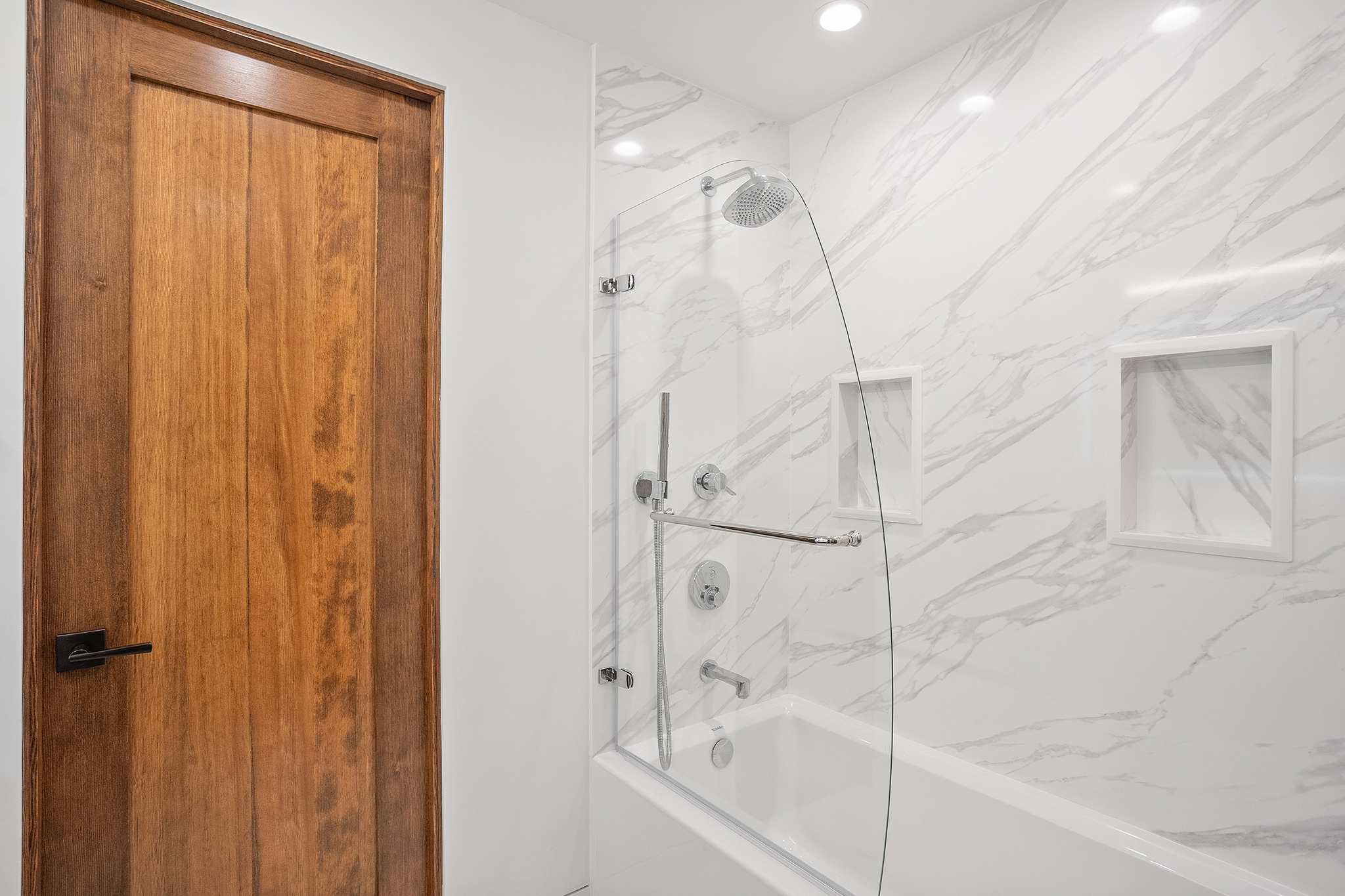 Custom quartz tub shower with built-in niches Richmond District San Francisco bathroom renovation