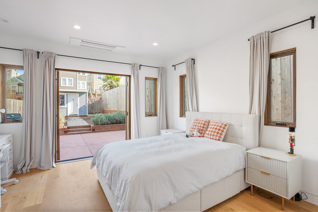 Bedroom with french doors doors to backyard patio in Richmond District San Francisco house remodel
